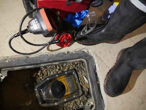 Technician performing basement flood inspection
